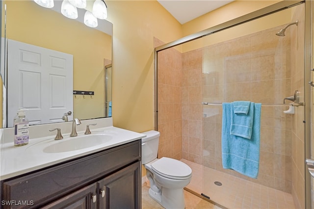 bathroom featuring vanity, walk in shower, and toilet