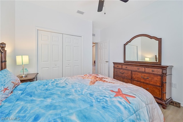 bedroom with ceiling fan, a closet, and light hardwood / wood-style flooring