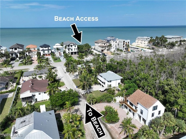 drone / aerial view featuring a water view and a residential view