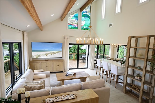 living room featuring light wood-type flooring, beam ceiling, high vaulted ceiling, and a chandelier