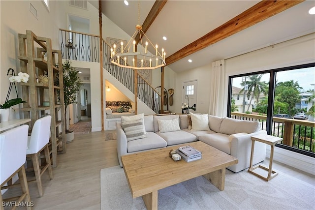 living area featuring visible vents, stairway, beam ceiling, high vaulted ceiling, and a notable chandelier