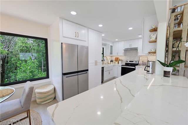 kitchen featuring stainless steel appliances, decorative backsplash, open shelves, and white cabinets