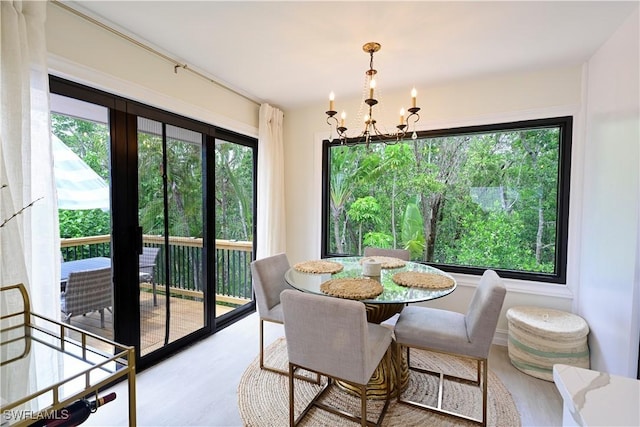 dining space featuring a notable chandelier and wood finished floors