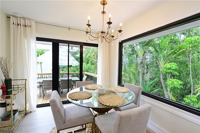 dining room featuring wood finished floors and a notable chandelier