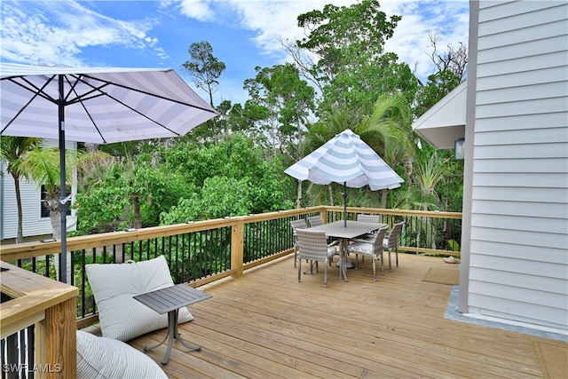 wooden deck featuring outdoor dining space