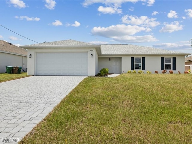 ranch-style house featuring a garage and a front lawn