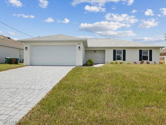 single story home featuring stucco siding, an attached garage, decorative driveway, and a front yard