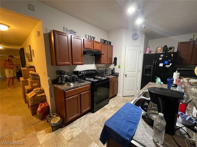 kitchen featuring track lighting, light tile patterned floors, and black appliances