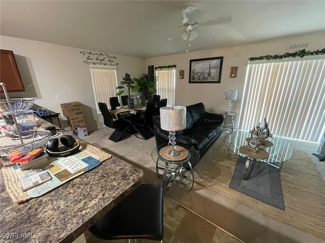 tiled living room with ceiling fan