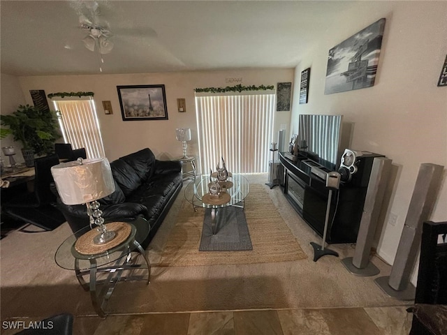 living room featuring ceiling fan and plenty of natural light