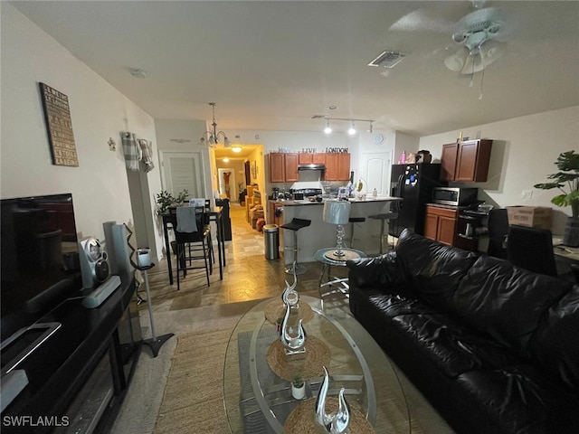 living room with ceiling fan, rail lighting, and light parquet floors