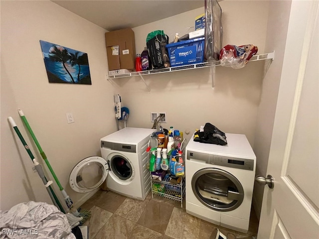 laundry room featuring tile patterned floors and washer and dryer