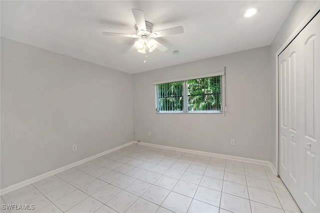 unfurnished bedroom featuring light tile patterned floors, ceiling fan, and a closet