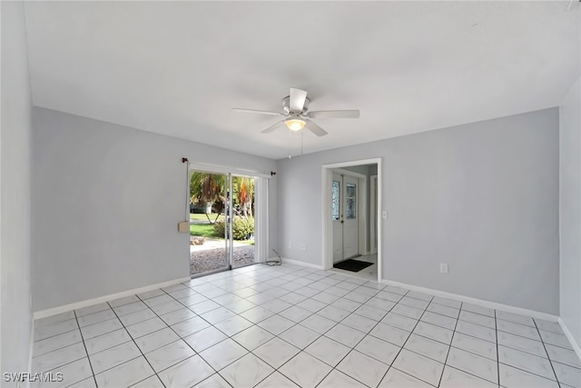 tiled spare room featuring ceiling fan