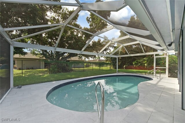 view of swimming pool with glass enclosure, a yard, and a patio