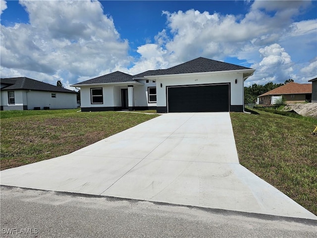 view of front of home featuring a garage and a front yard