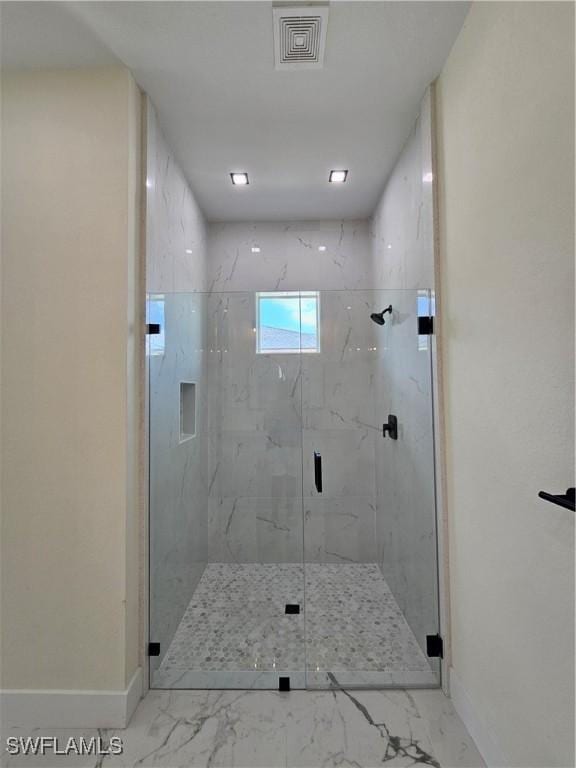 bathroom featuring a shower with door