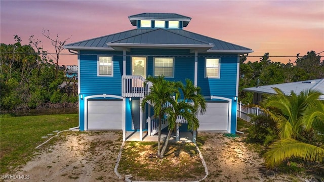 view of front of home featuring a garage and a yard