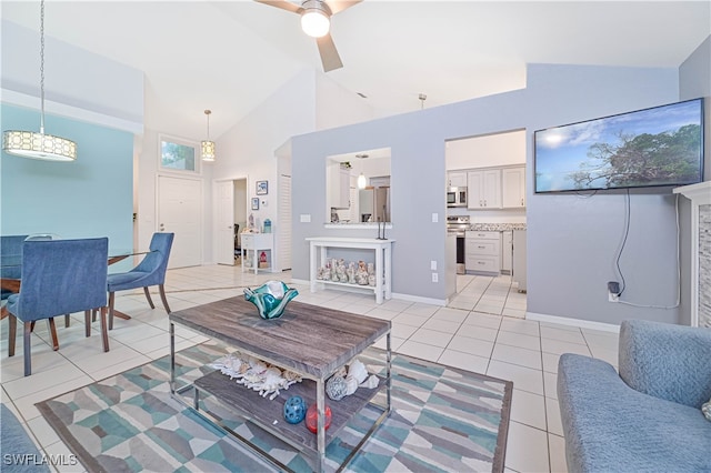 living room featuring ceiling fan, light tile patterned floors, and high vaulted ceiling