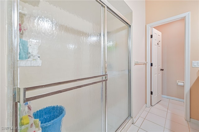 bathroom with tile patterned floors and an enclosed shower