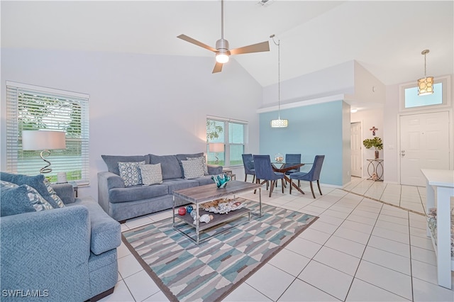 living room with light tile patterned floors, high vaulted ceiling, and ceiling fan