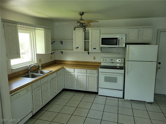 kitchen featuring ceiling fan, sink, light tile patterned flooring, and white appliances