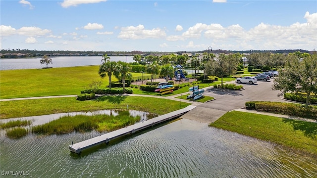 view of home's community with a yard and a water view