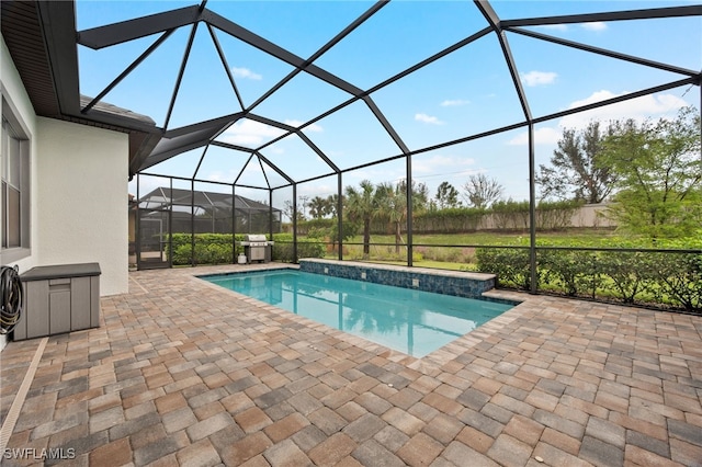 view of swimming pool featuring a patio and a lanai