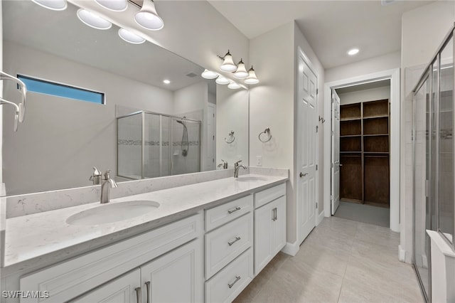 bathroom featuring vanity, an enclosed shower, and tile patterned floors