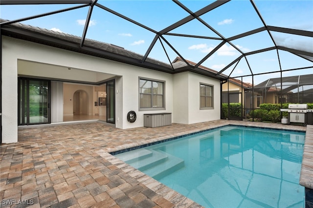 view of swimming pool with a patio and glass enclosure