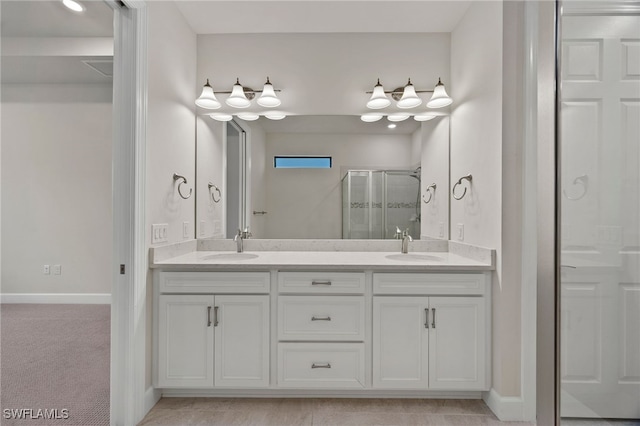 bathroom with vanity and a shower with door