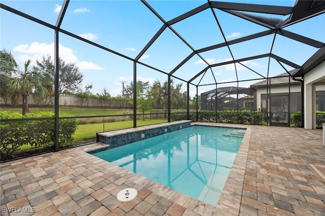 view of swimming pool with a patio area, glass enclosure, and a lawn