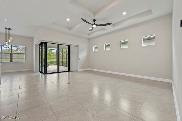 empty room featuring coffered ceiling, ceiling fan with notable chandelier, and light tile patterned floors