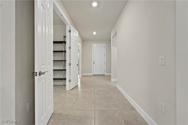 hall with light tile patterned flooring