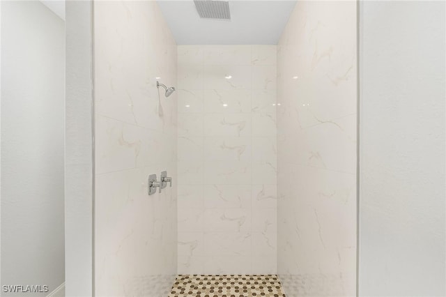 bathroom with tiled shower