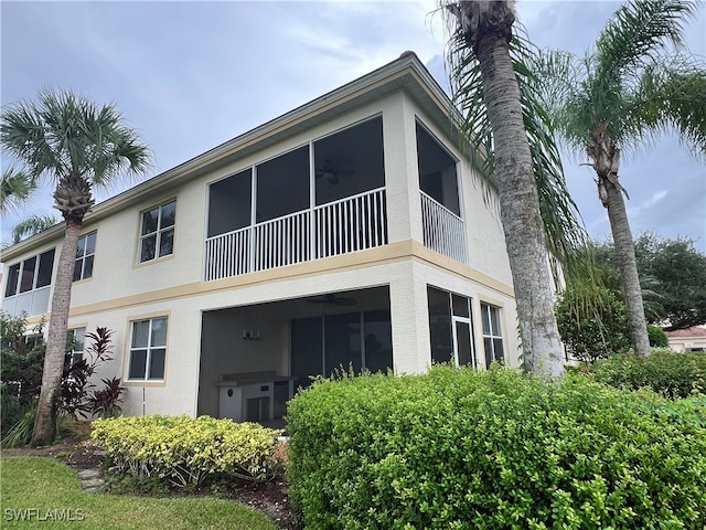 rear view of house with ceiling fan