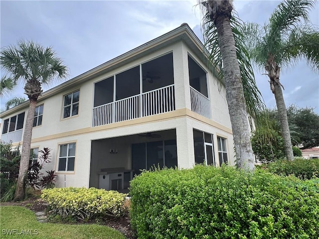 back of property with ceiling fan