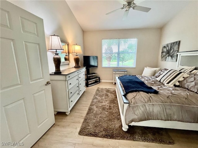 3020 Meandering Way Unit 201, Fort Myers, FL 33905 - bedroom with light wood-style floors, vaulted ceiling, and a ceiling fan