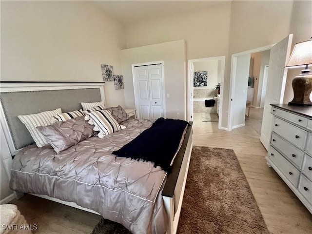 3020 Meandering Way Unit 201, Fort Myers, FL 33905 - bedroom featuring light wood-type flooring, a high ceiling, and a closet