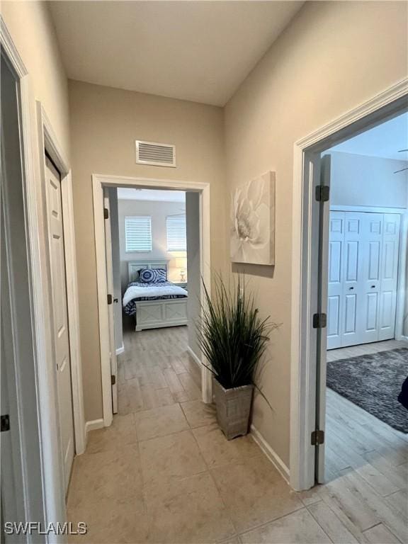 3020 Meandering Way Unit 201, Fort Myers, FL 33905 - hall with baseboards and light tile patterned flooring