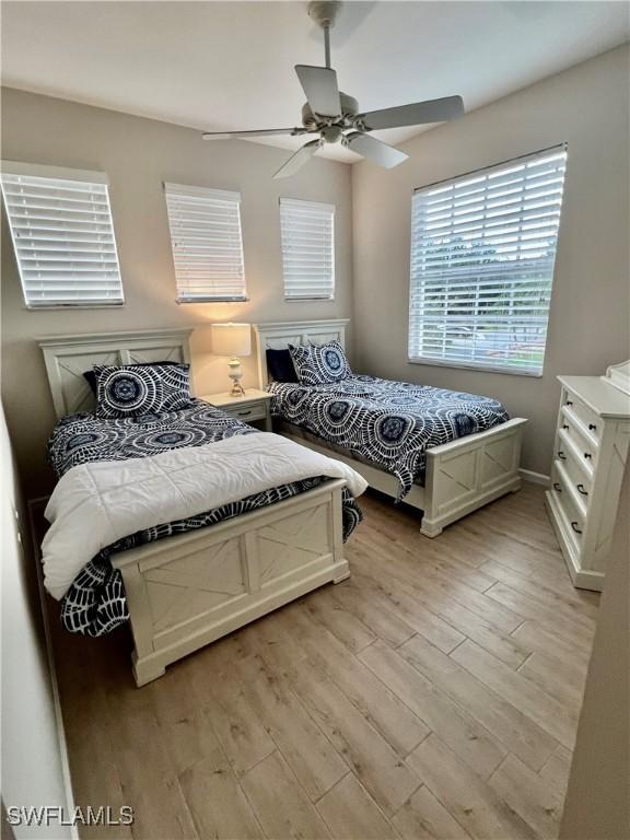 3020 Meandering Way Unit 201, Fort Myers, FL 33905 - bedroom featuring light wood-style floors and ceiling fan