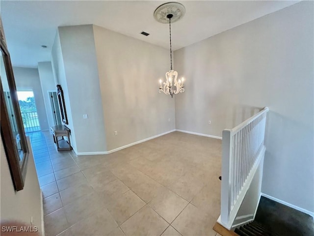 3020 Meandering Way Unit 201, Fort Myers, FL 33905 - spare room with tile patterned floors and a chandelier