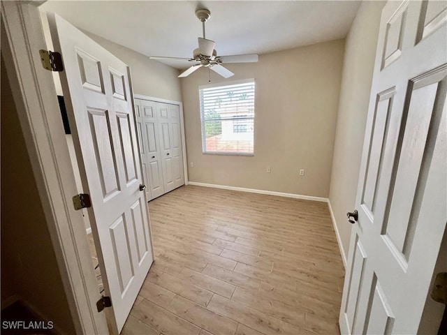 3020 Meandering Way Unit 201, Fort Myers, FL 33905 - unfurnished bedroom featuring light wood-style flooring and a ceiling fan