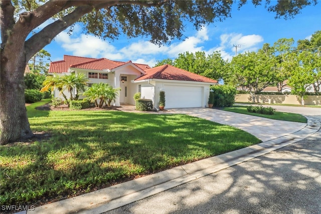 mediterranean / spanish-style home featuring a garage and a front lawn