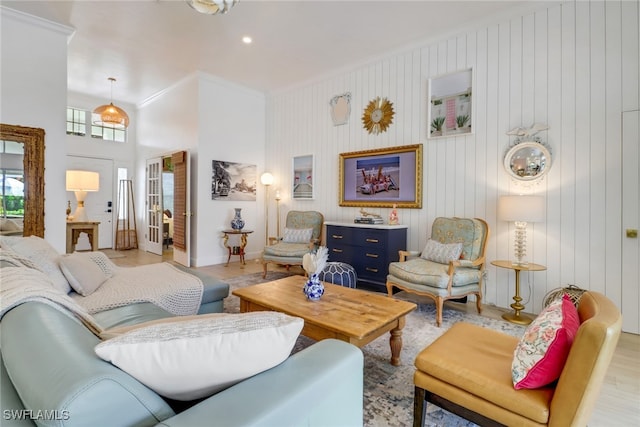 living room with light hardwood / wood-style flooring and ornamental molding