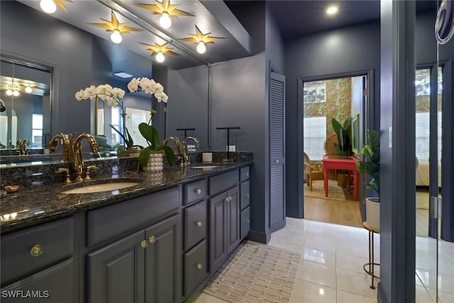 bathroom with tile patterned flooring, ceiling fan, and vanity