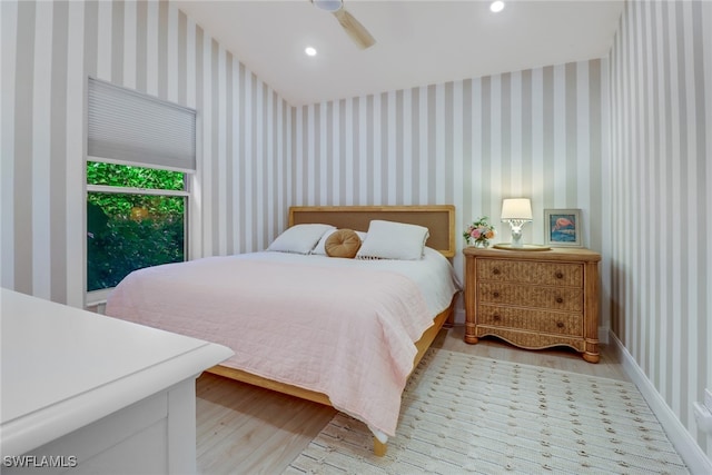 bedroom with ceiling fan and light hardwood / wood-style floors