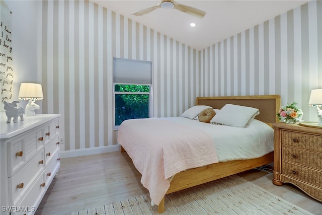 bedroom with ceiling fan and light hardwood / wood-style floors