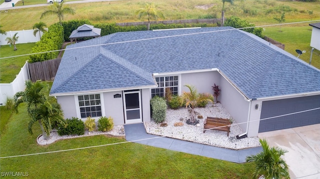 view of front of house with a front yard and a garage