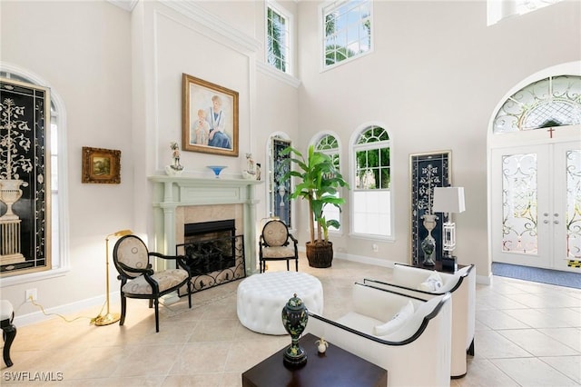 tiled living room featuring french doors and a towering ceiling